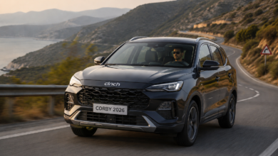 Cinch Corby 2026 SUV driving on a scenic coastal road with a driver behind the wheel